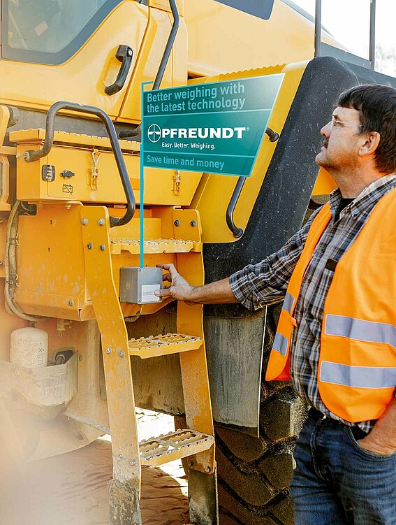 PFREUNDT industries – overview Man checks data on large, yellow construction site vehicle